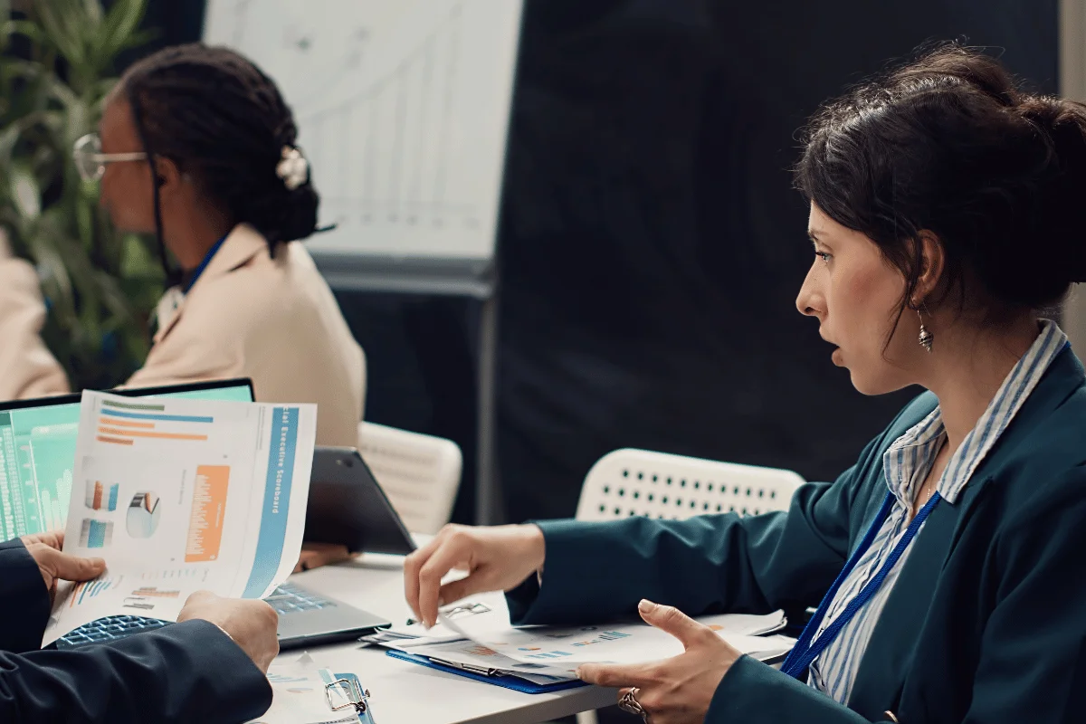 Team discussing financial charts and reports during a business meeting.